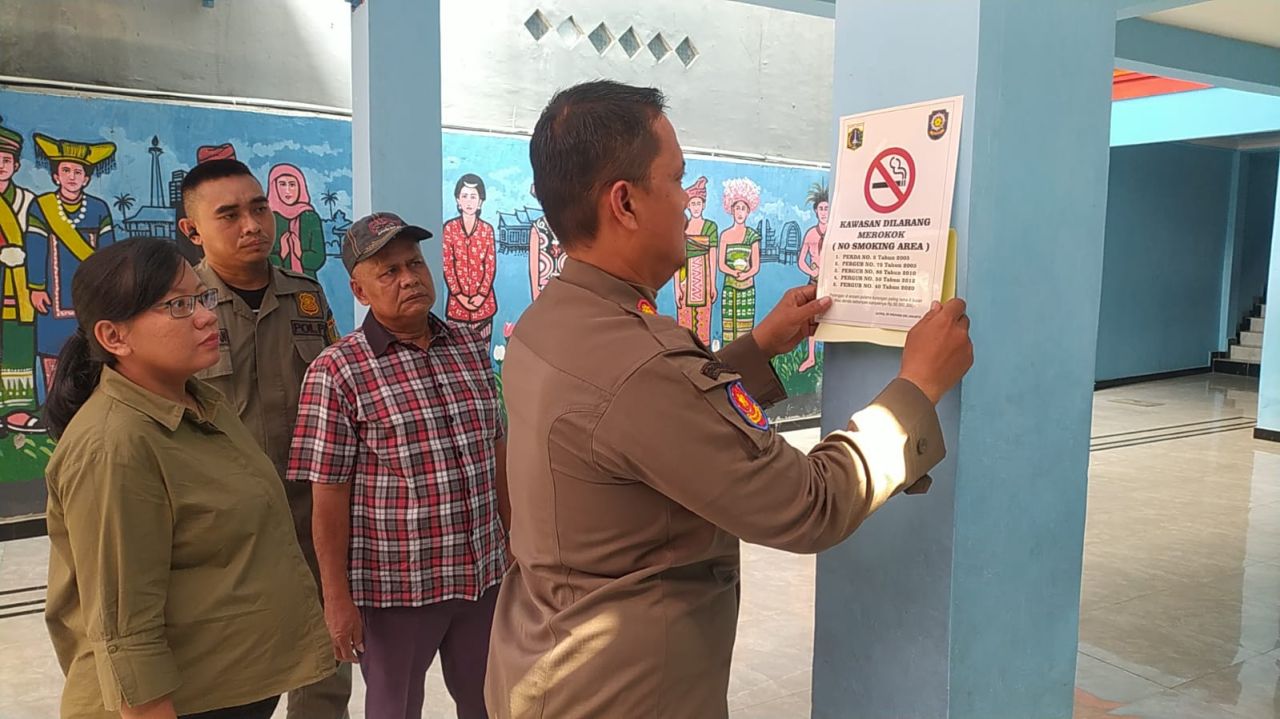 Satpol Kelurahan Kemayoran Pasang Stiker "Kawasan Dilarang Merokok" di Sejumlah Sekolah